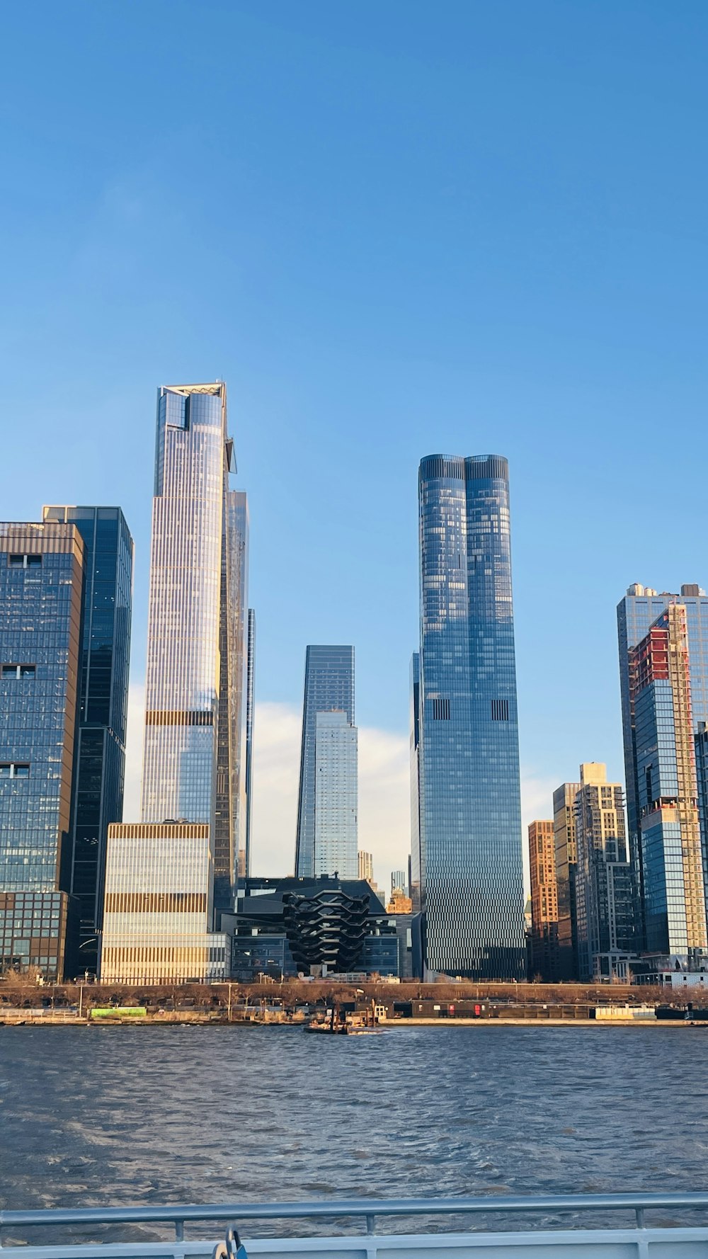 a boat traveling down a river next to tall buildings