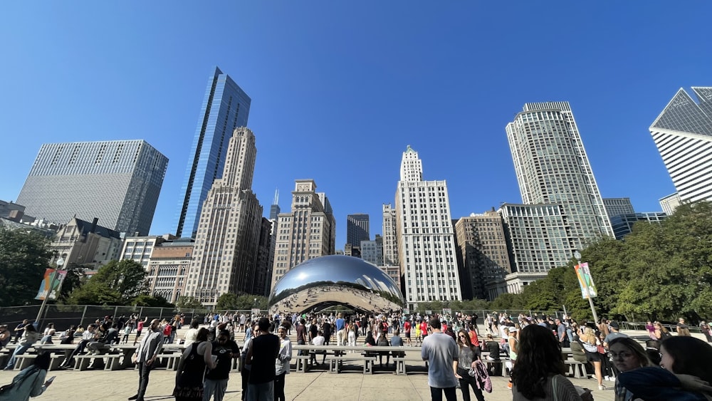 a group of people standing around a large metal ball