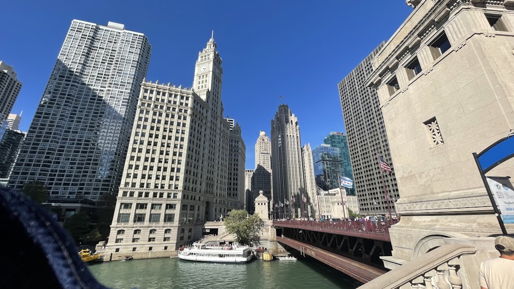 a boat traveling down a river next to tall buildings