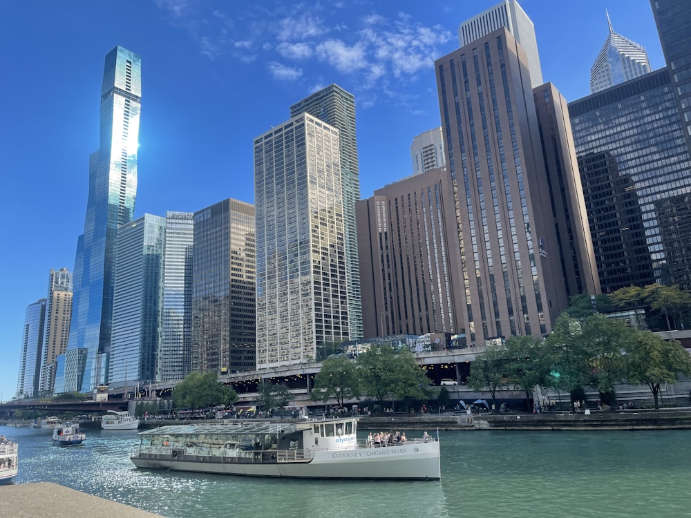 a boat traveling down a river next to tall buildings