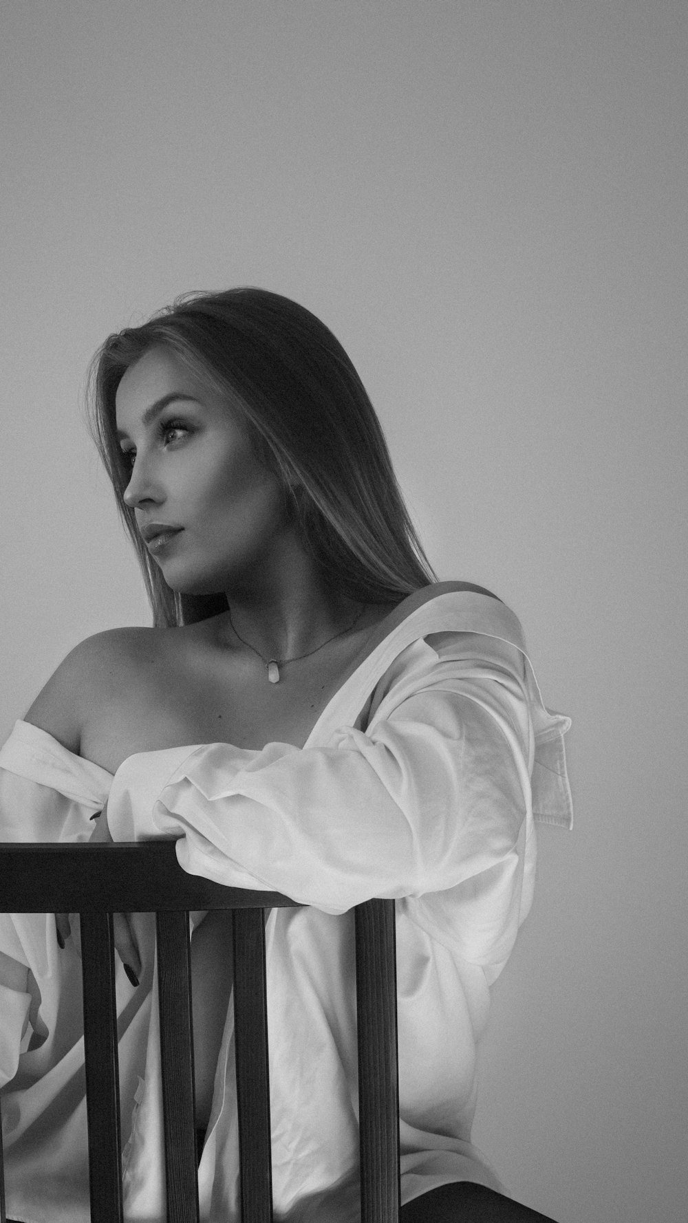 a black and white photo of a woman sitting in a chair