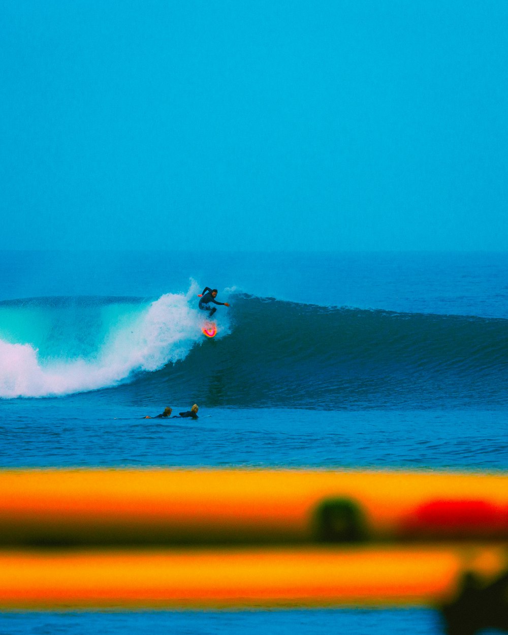 a man riding a wave on top of a surfboard