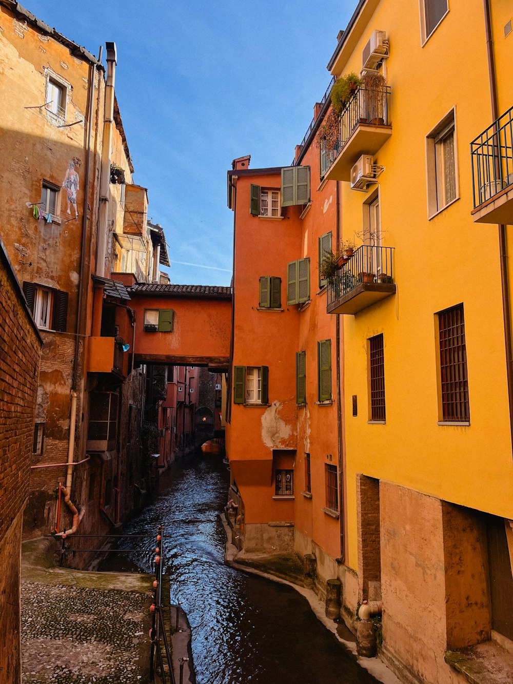 a river running between two buildings in a city