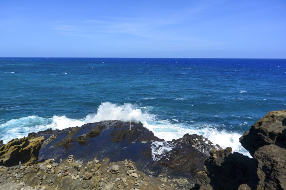 a view of the ocean from a rocky shore