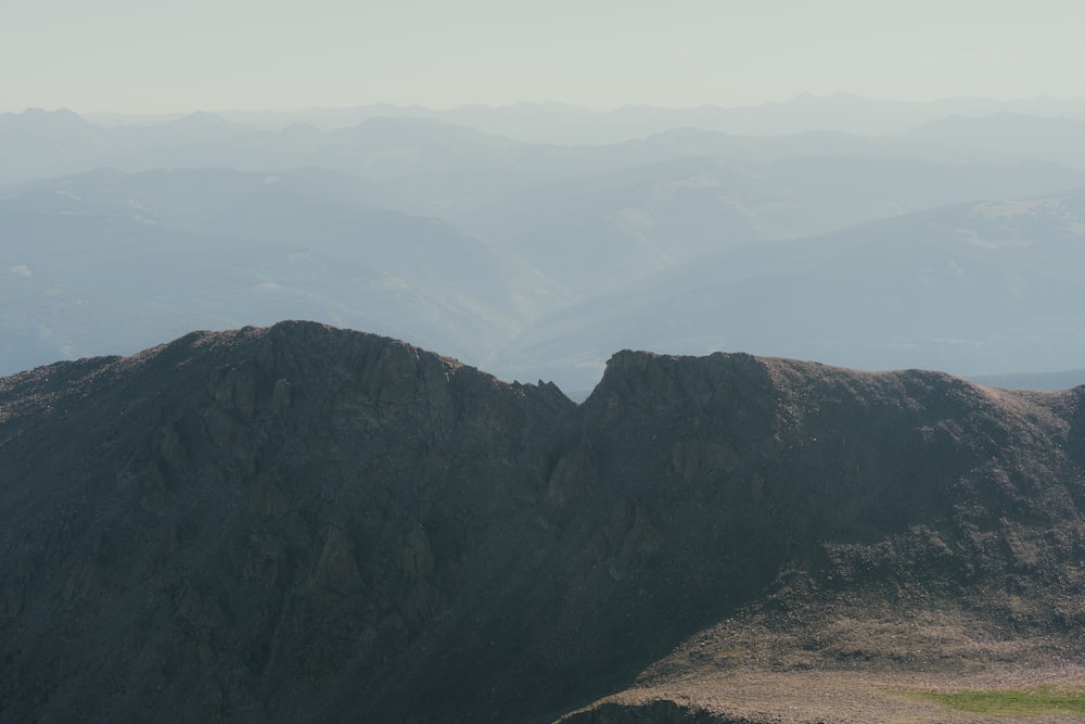 a view of a mountain range from the top of a hill