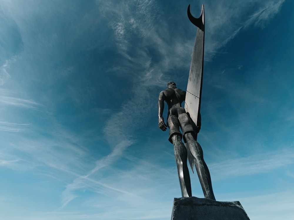 a statue of a man holding a giant knife