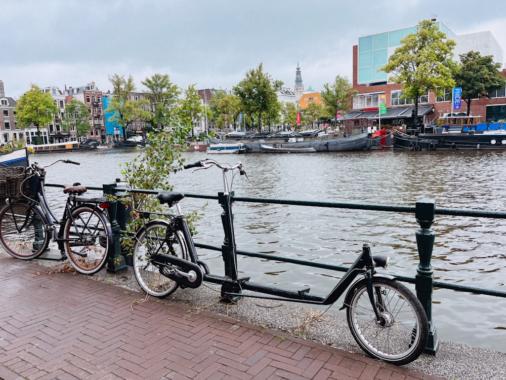 two bikes parked next to each other on a bridge