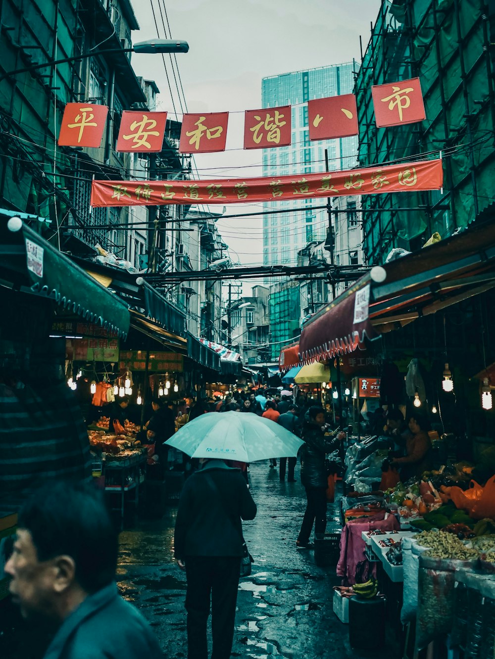 a person walking down a street holding an umbrella