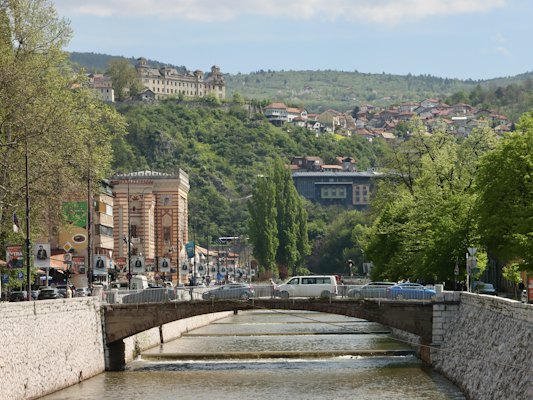 A river running through a city with a bridge over it — Sarajevo, Bosnia and Herzegovina
