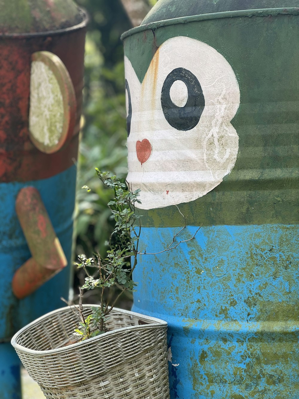 a close up of a trash can with a plant growing out of it