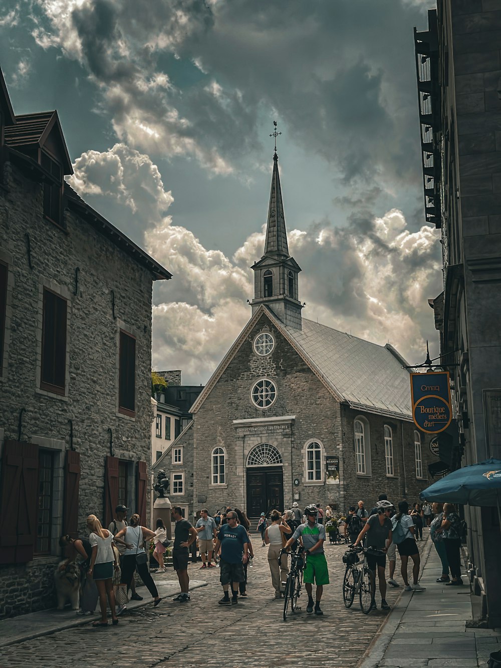 a group of people walking down a street next to a church