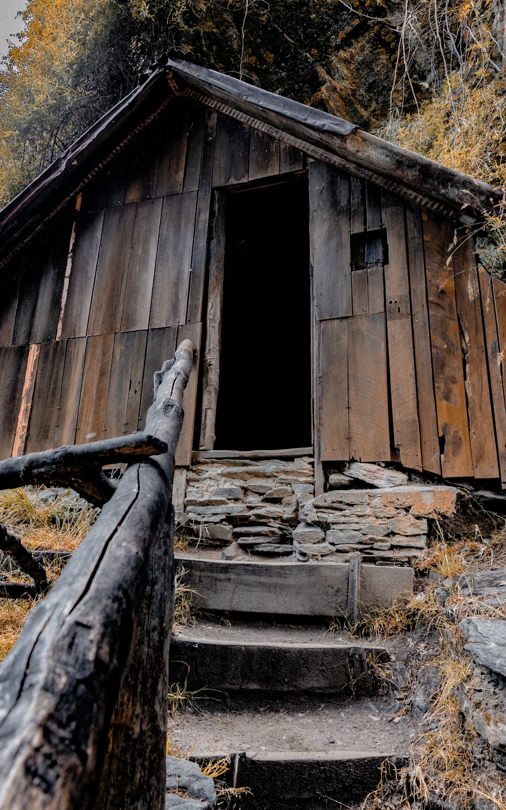 a wooden cabin with steps leading up to it