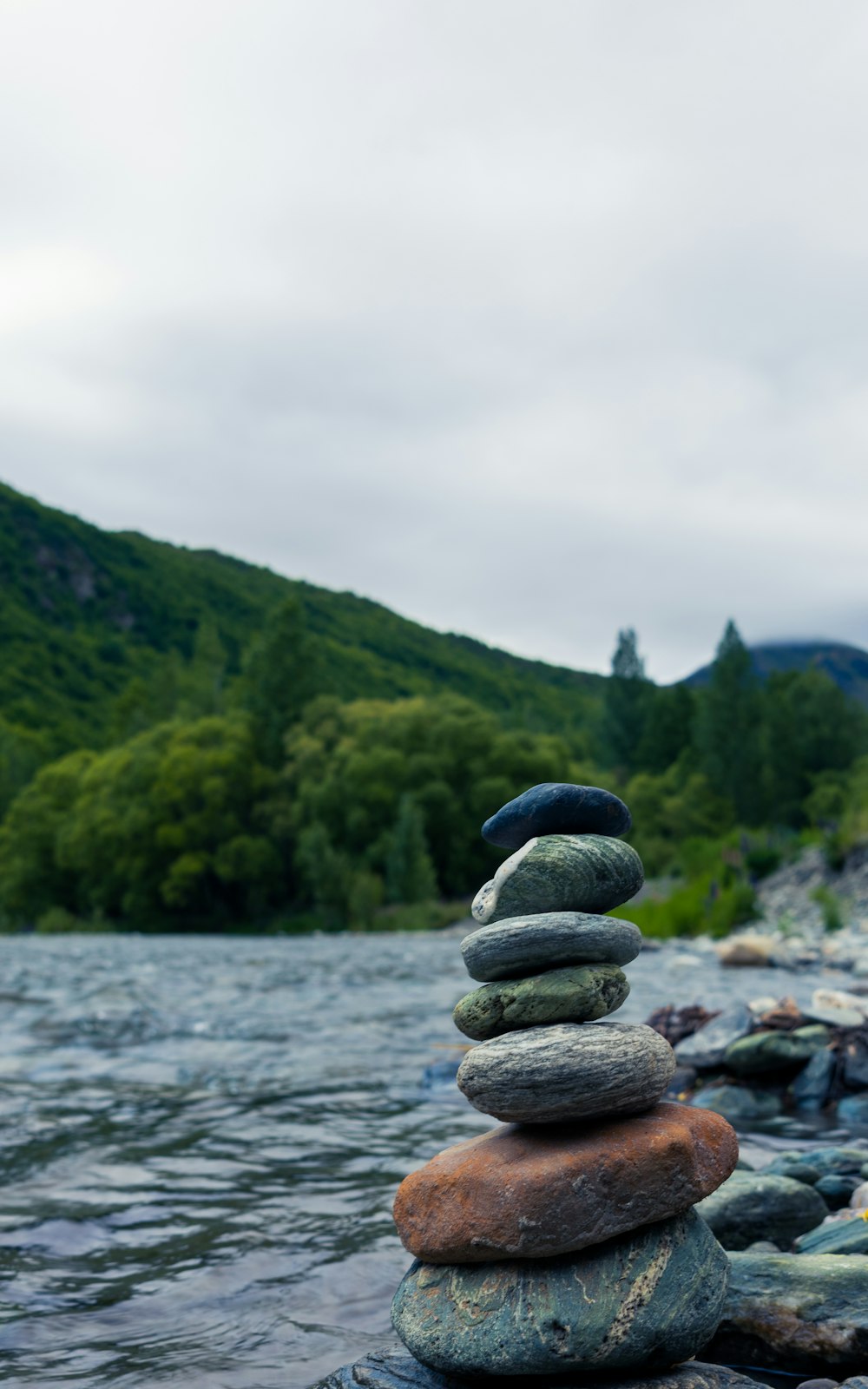 a stack of rocks sitting on top of a river
