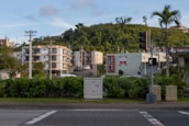 a stop light on a city street with a hill in the background