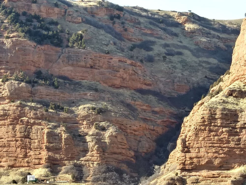 a rocky mountain with a house on top of it