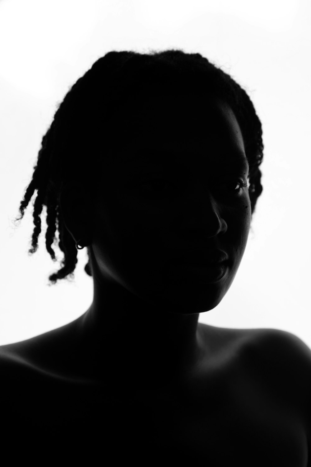 a black and white photo of a woman with dreadlocks