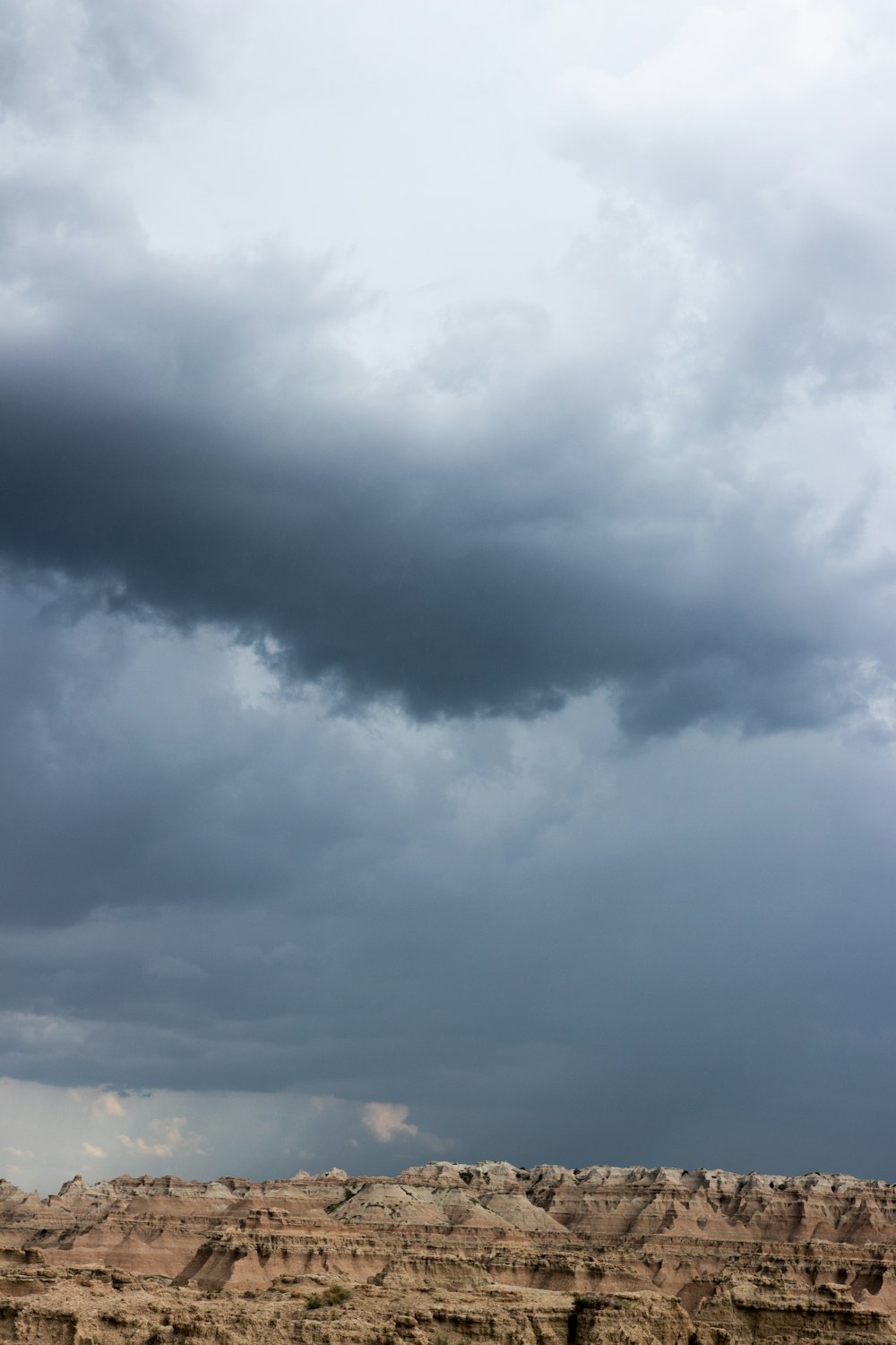 a cloudy sky over a vast desert landscape