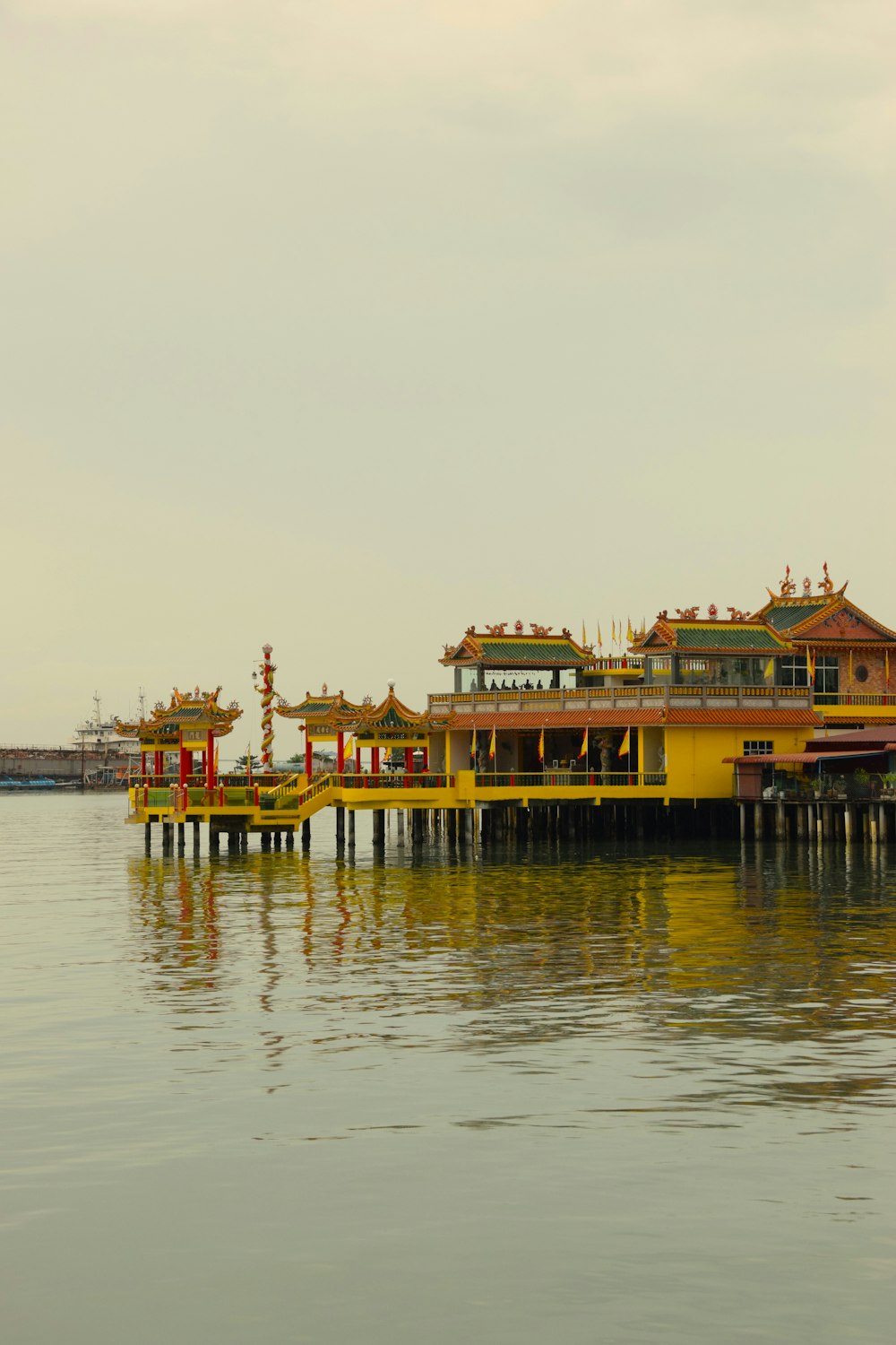 a yellow building sitting on top of a body of water