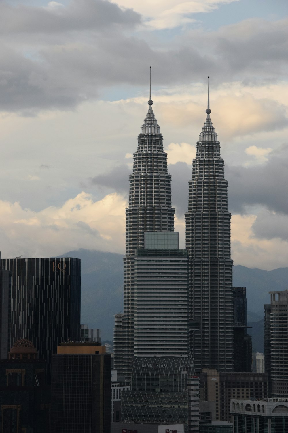 a plane flying over a city with tall buildings