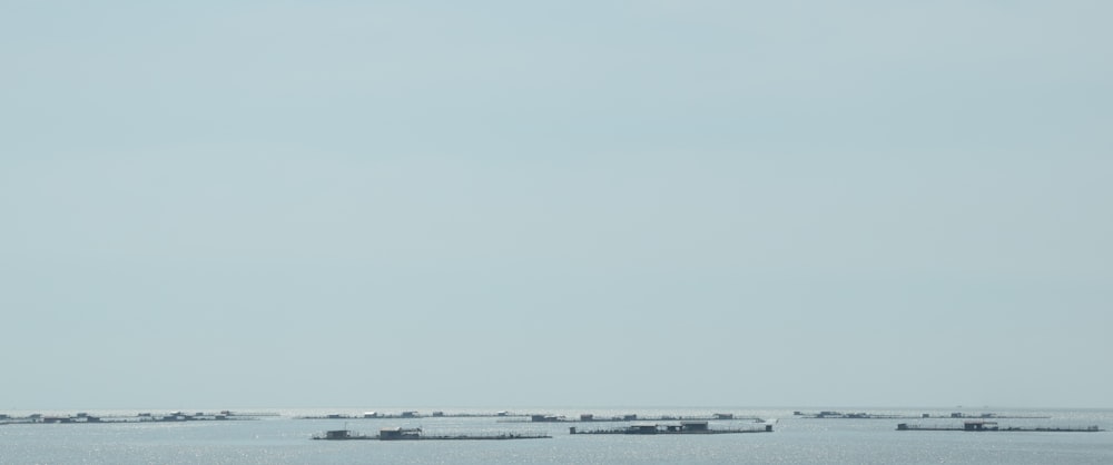 a group of boats floating on top of a large body of water