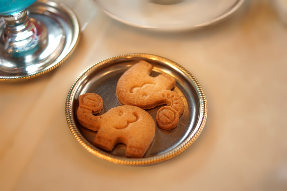 a plate of cookies shaped like elephants on a table
