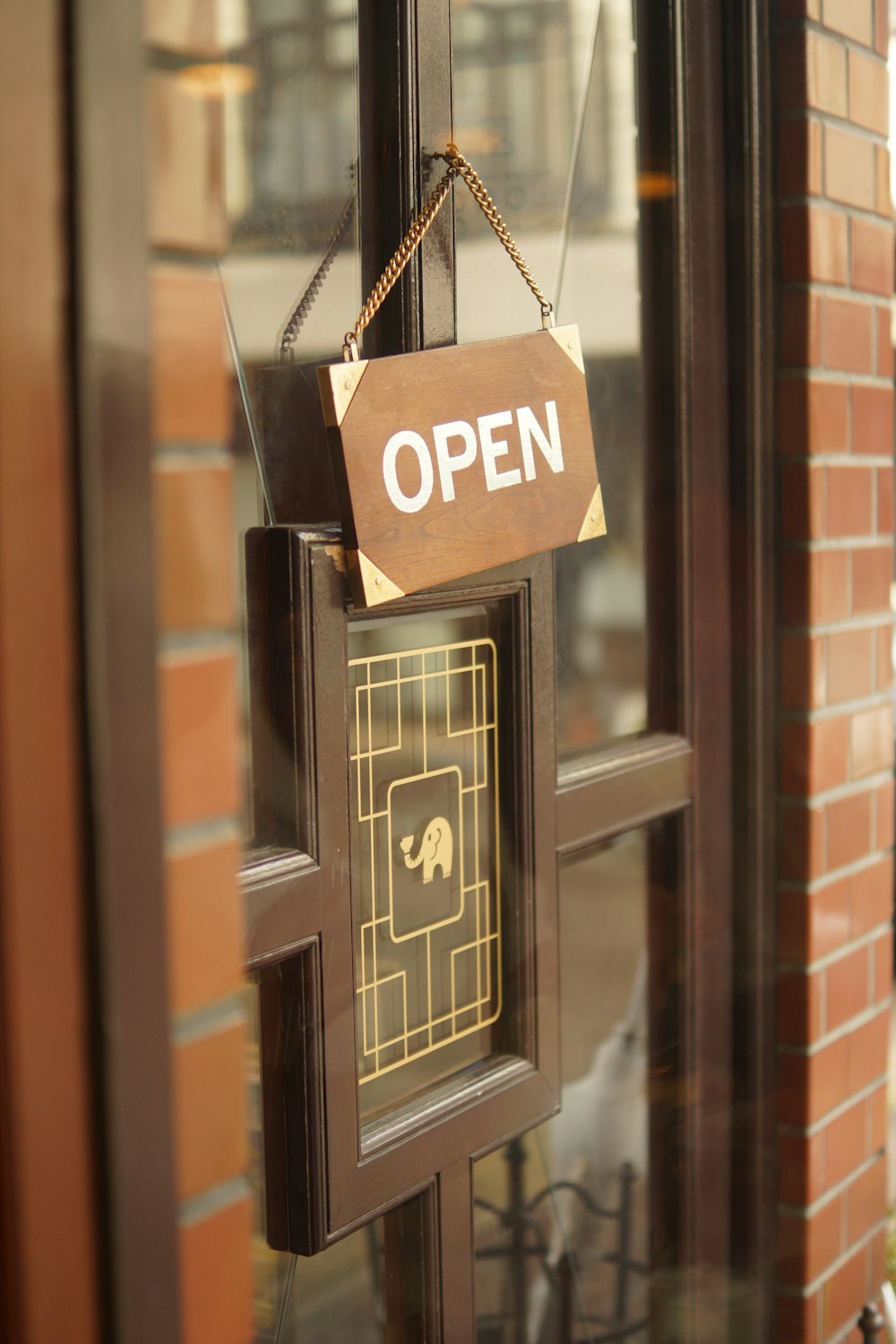 a sign hanging on a door that says open