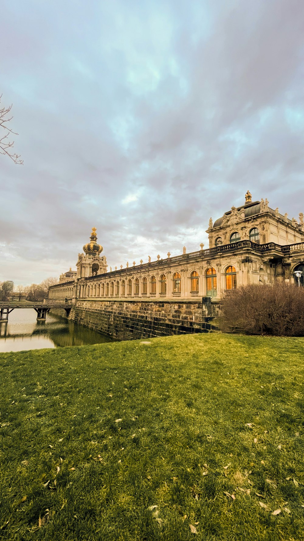 a large building sitting on top of a lush green field