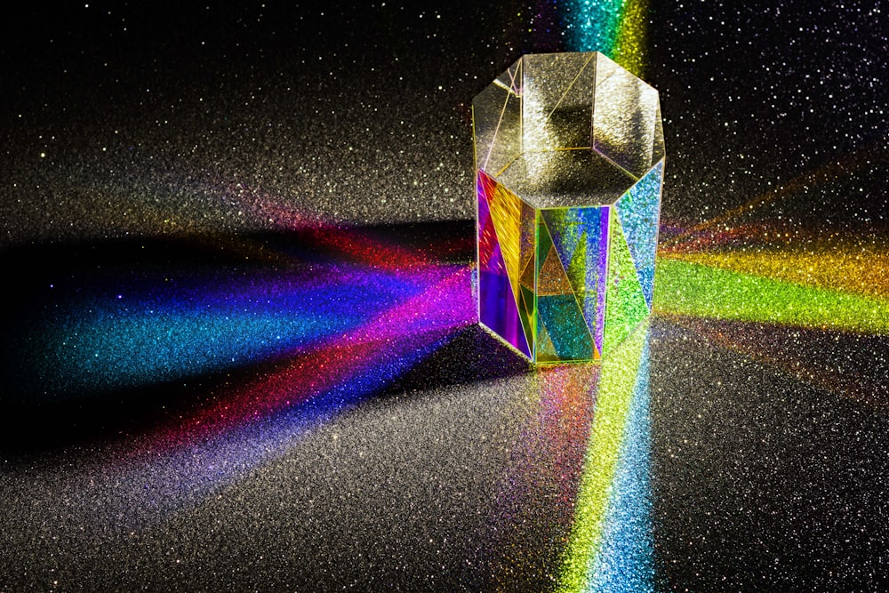 a colorful object with a rainbow light coming out of it