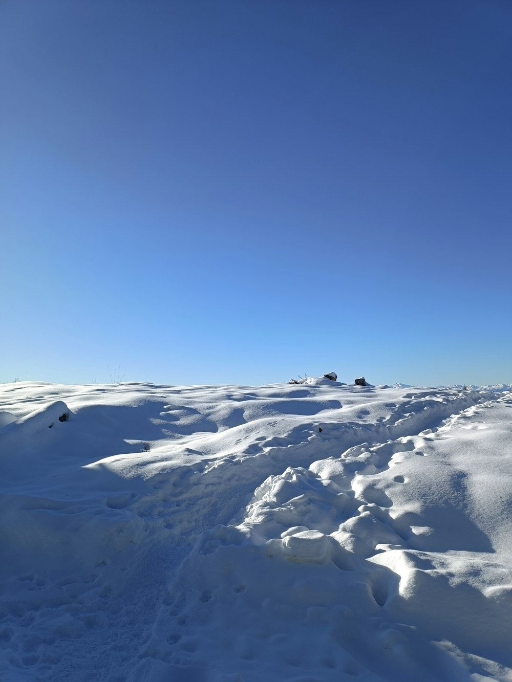 a person riding skis on top of a snow covered slope