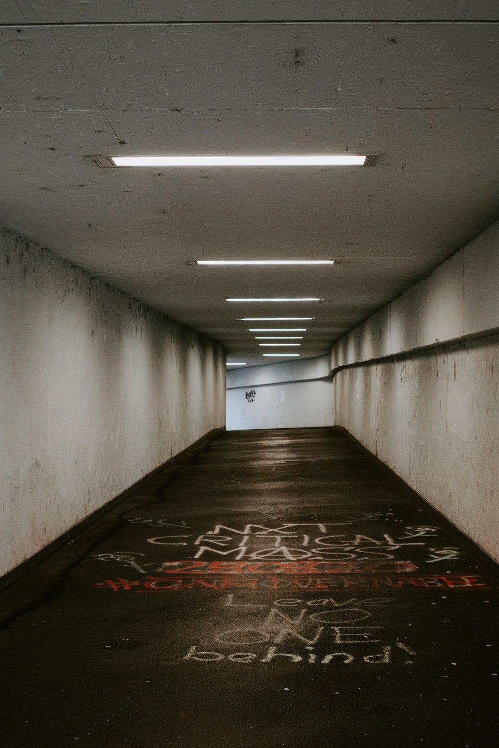 an empty parking garage with graffiti on the floor