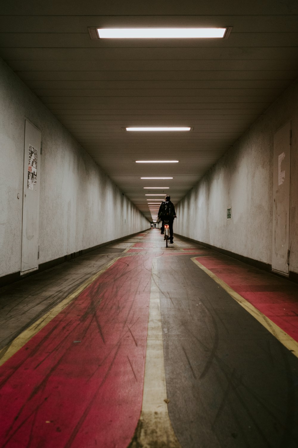 a man riding a bike down a tunnel