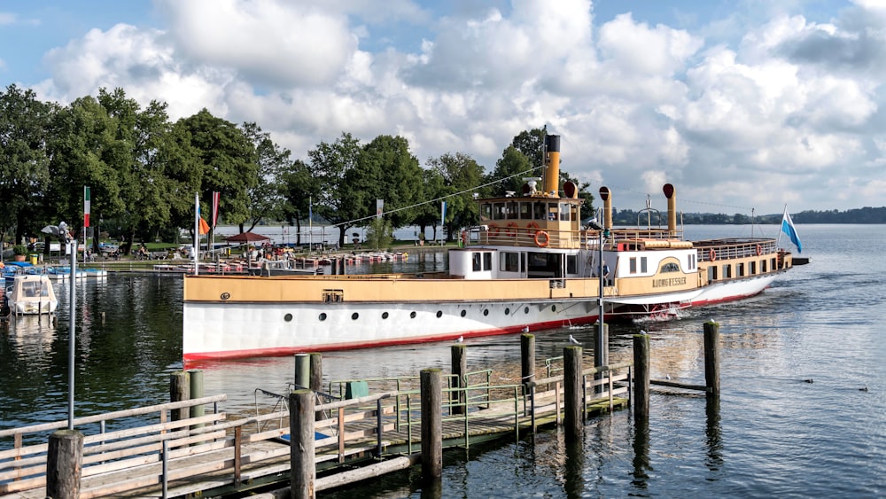 a large boat is docked at a pier