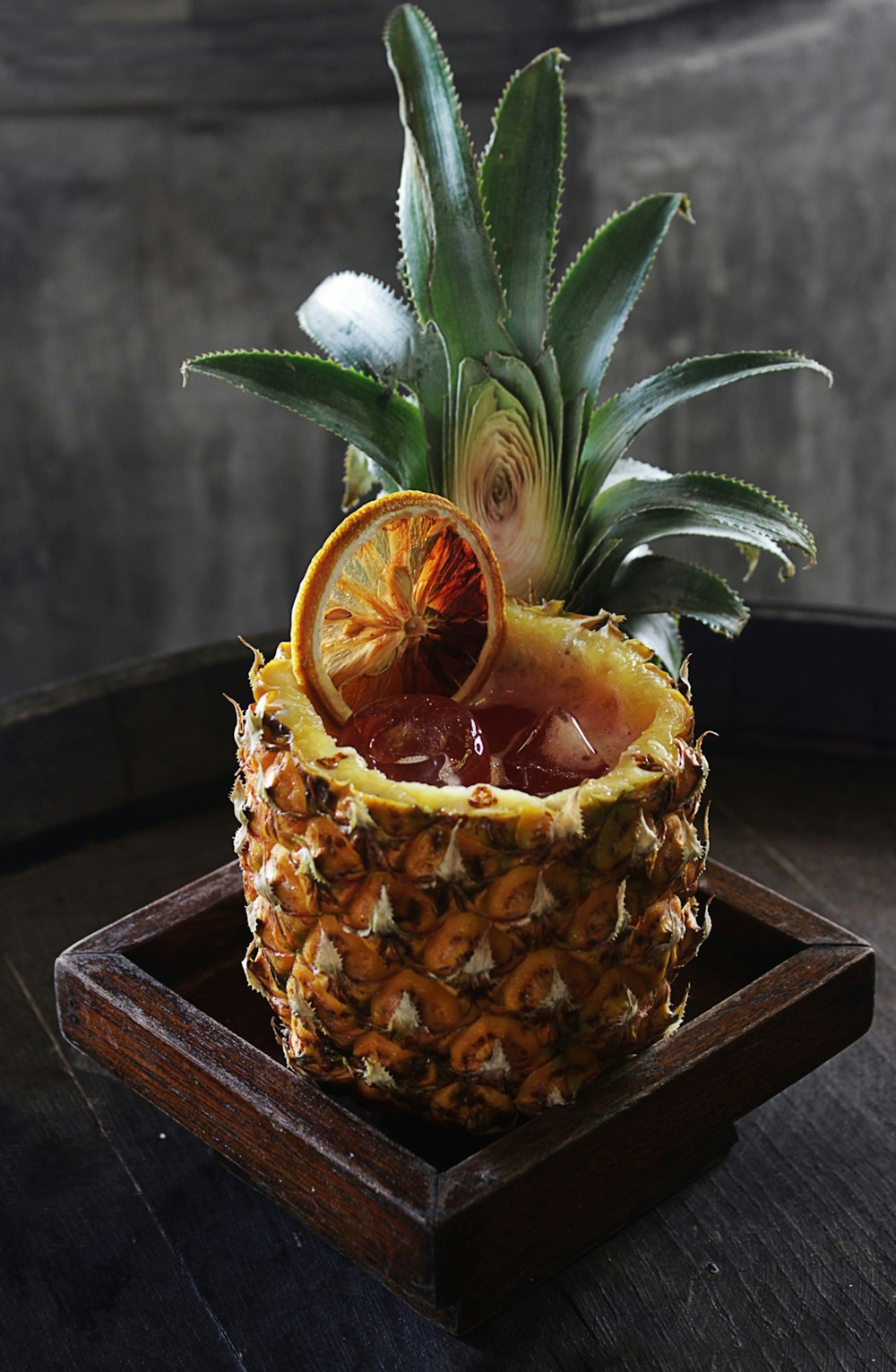a pineapple sitting on top of a wooden tray