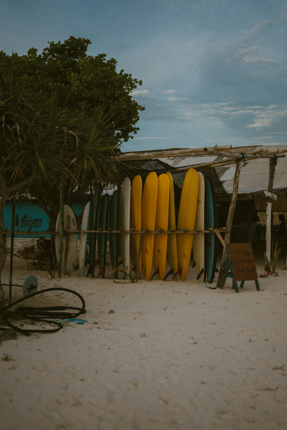 a bunch of surfboards are stacked on a rack