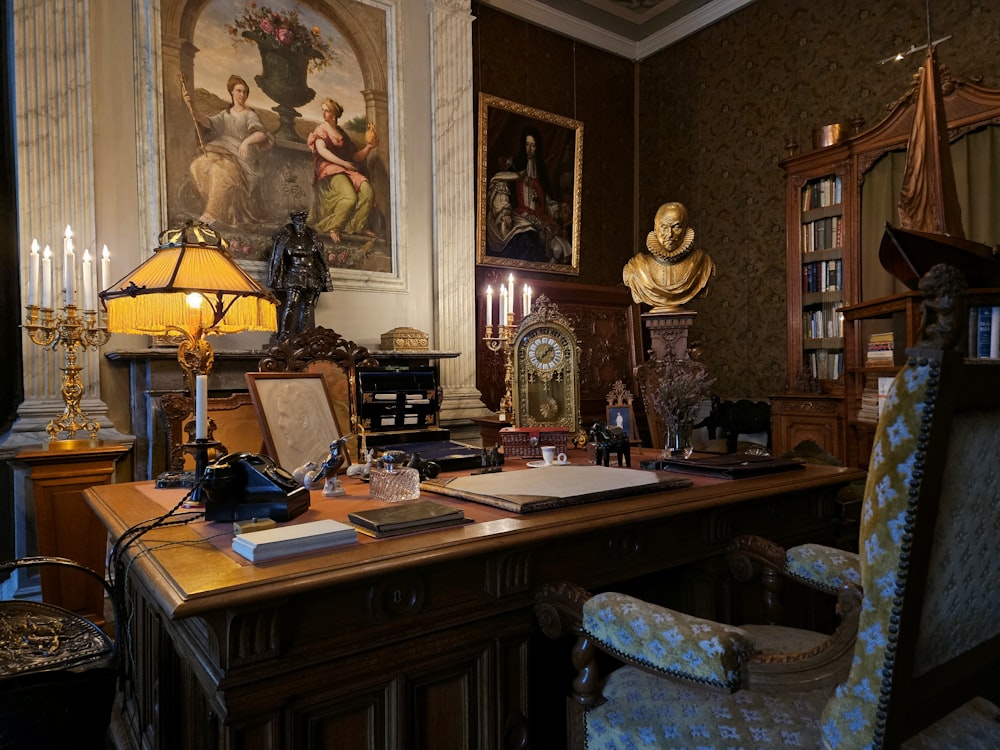 a desk with a lamp and a painting on the wall