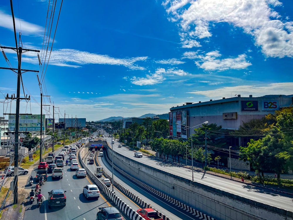 a city street filled with lots of traffic under a blue sky