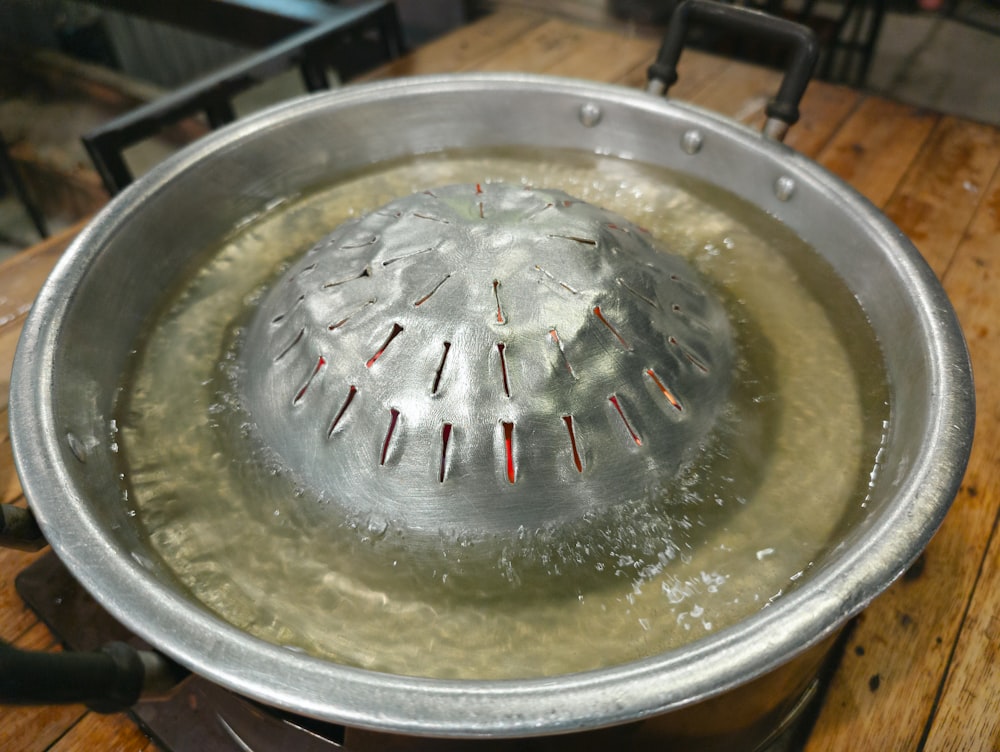a large metal pot with water inside of it