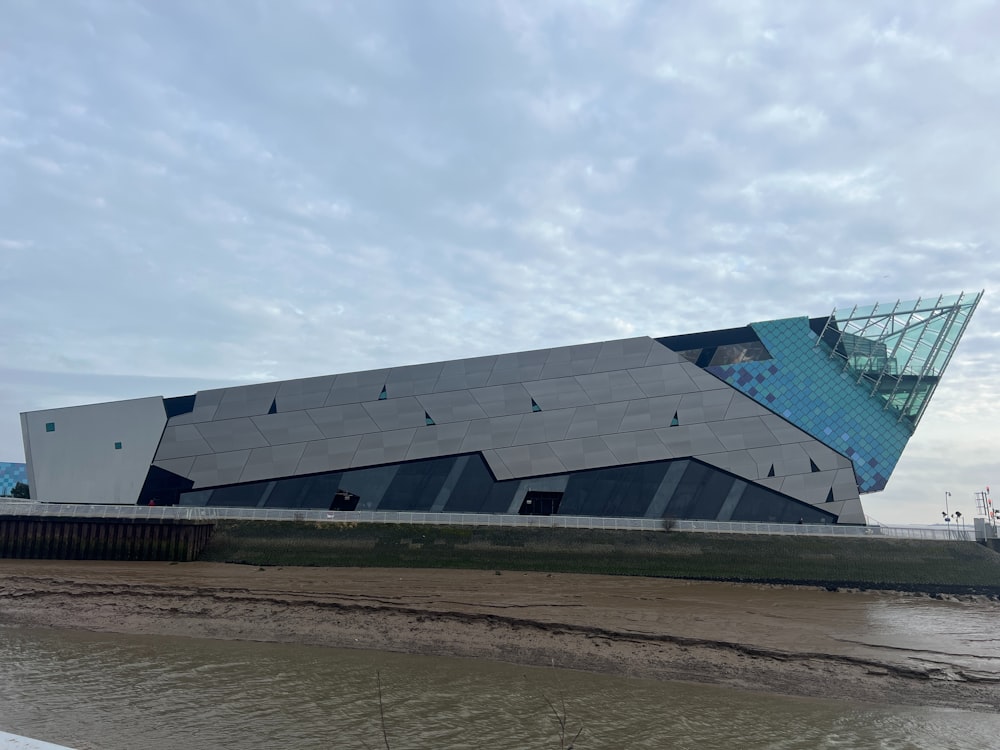 a large building sitting next to a body of water