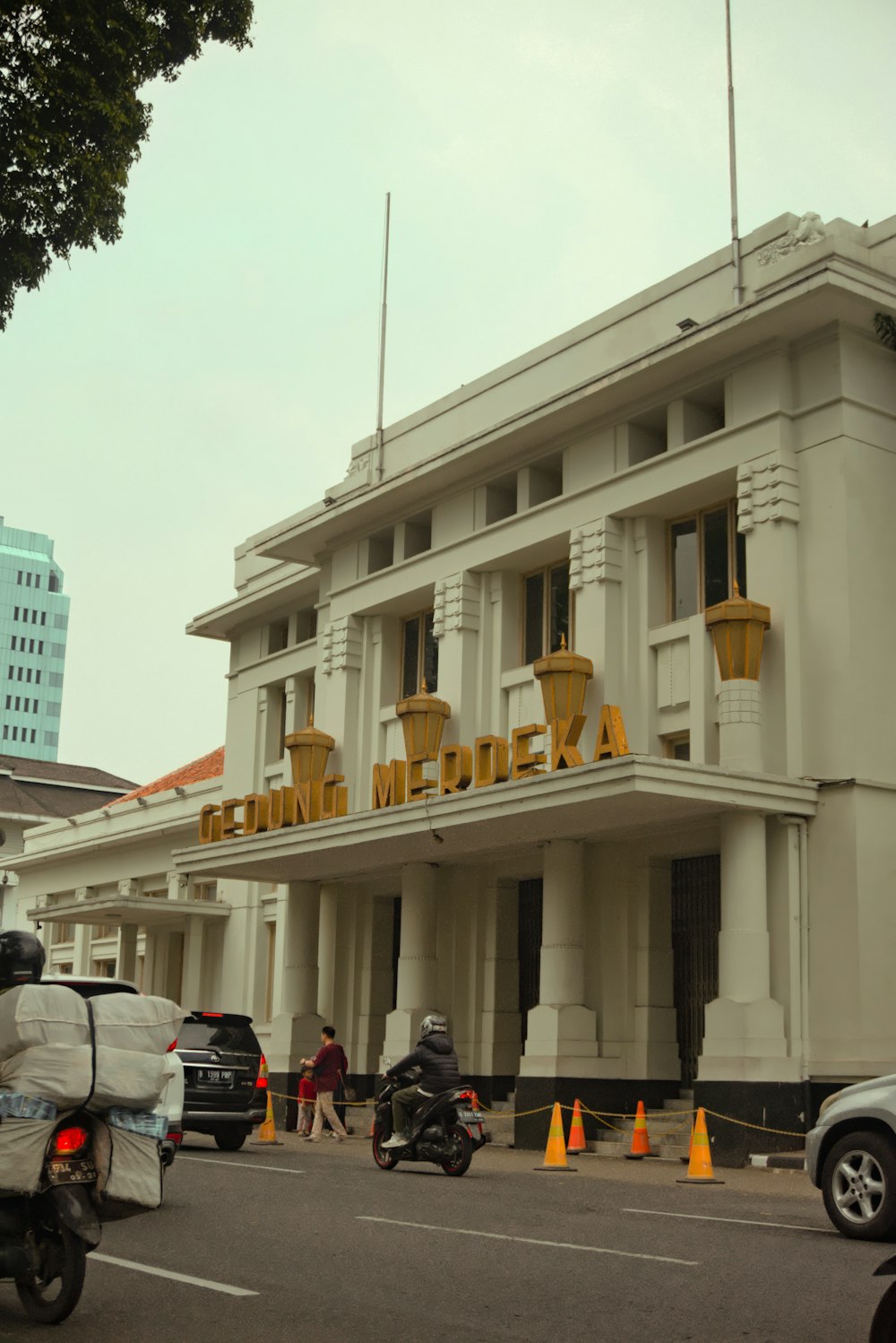 a large white building with a yellow sign on it