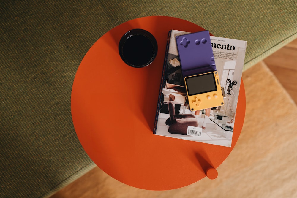 a magazine sitting on top of a table next to a cup of coffee