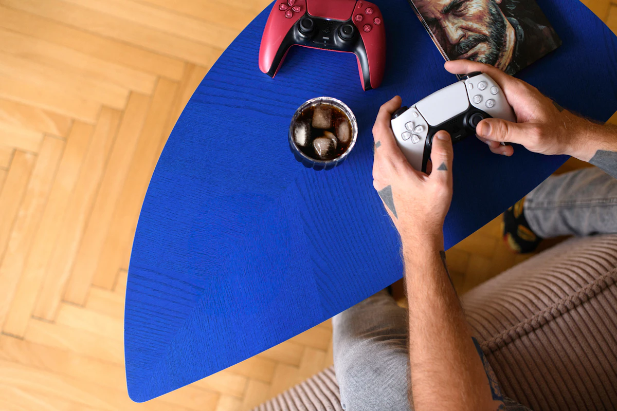 a man sitting at a table playing a video game