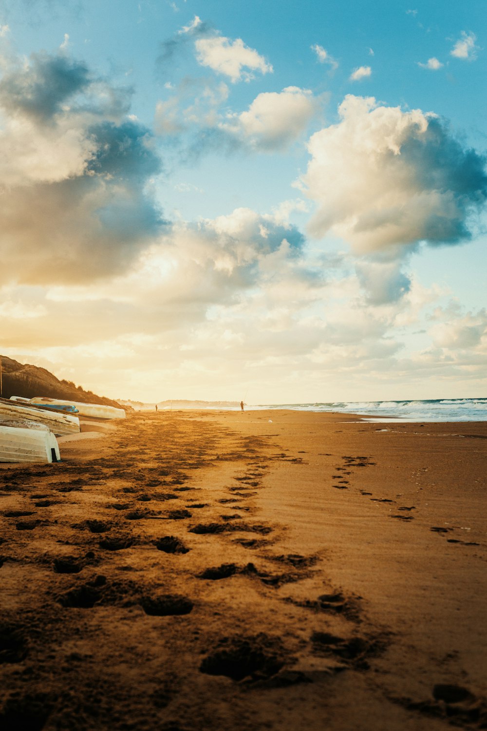 a car parked on a beach next to the ocean