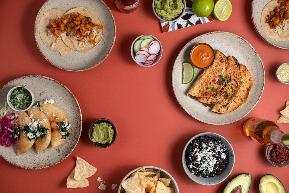 a table topped with plates of food and drinks