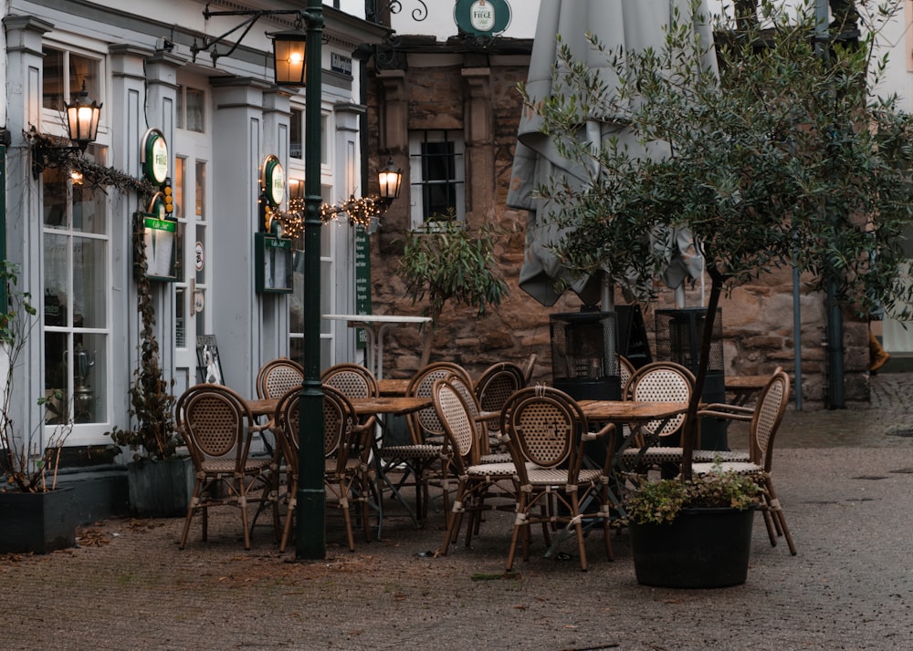 a group of tables and chairs outside of a building