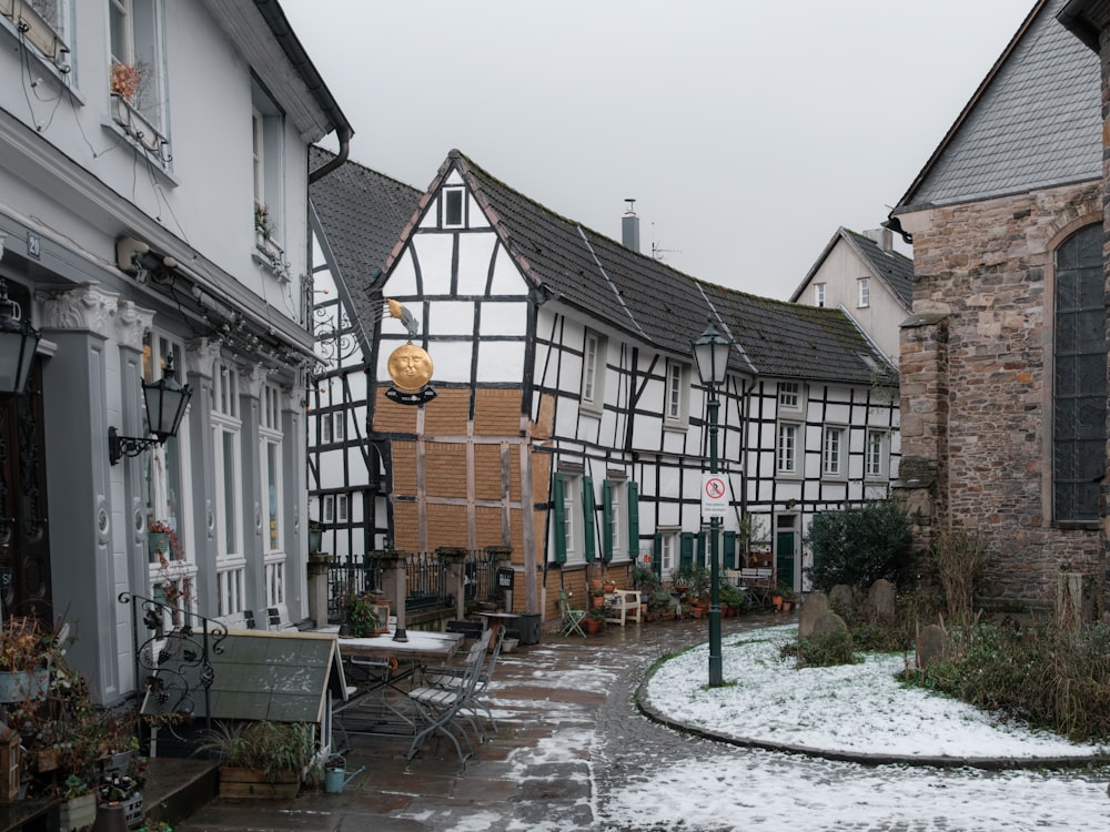 a row of houses on a street with snow on the ground