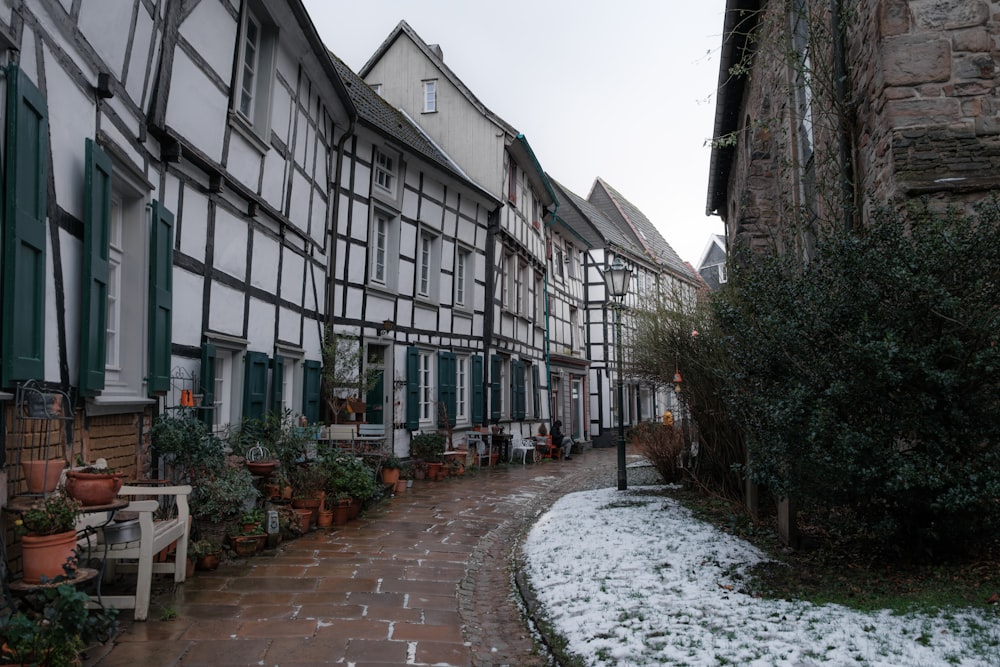 a row of houses with green shutters on the windows