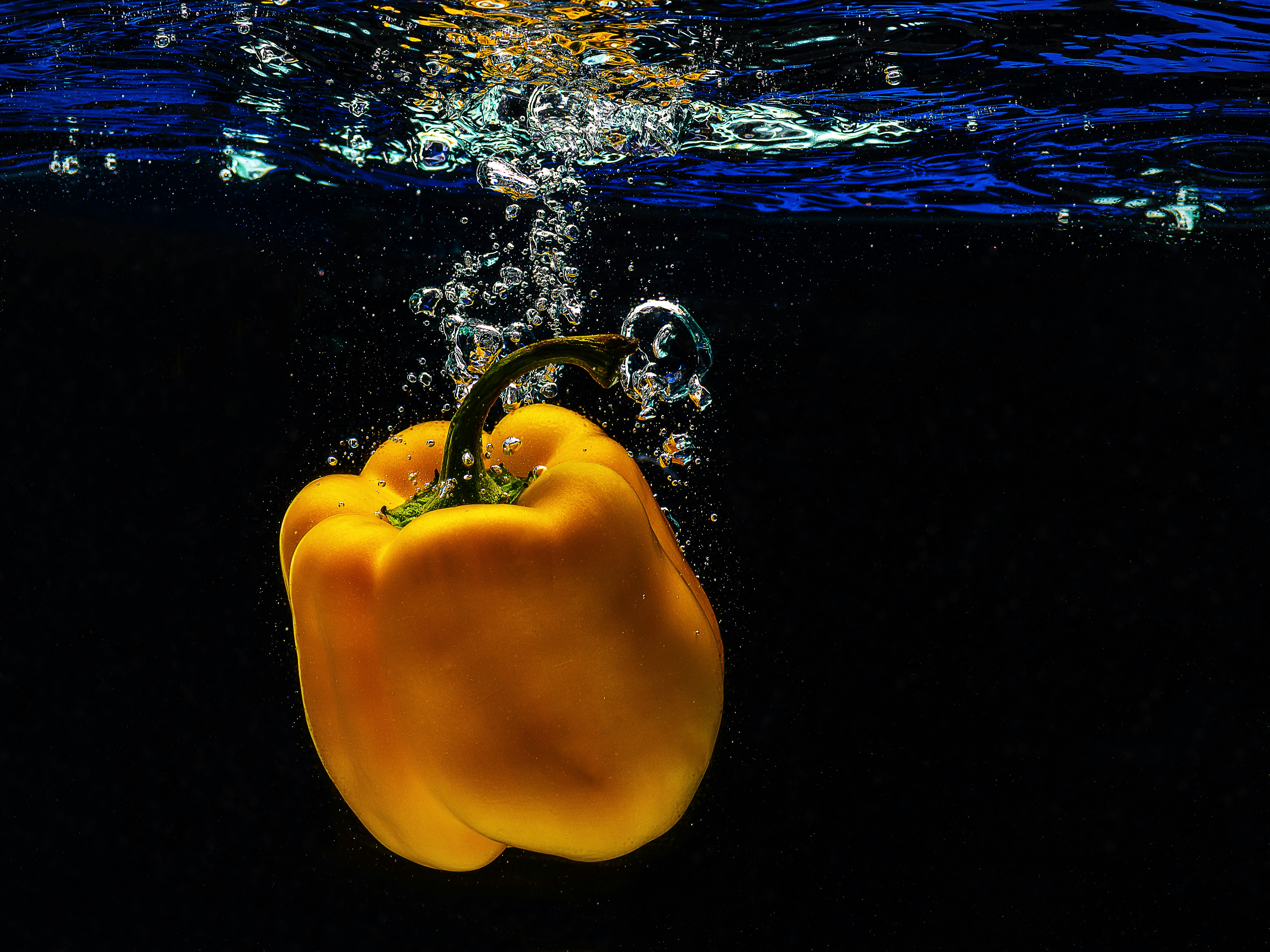 A yellow pepper is floating in the water photo – Free Bell pepper Image ...