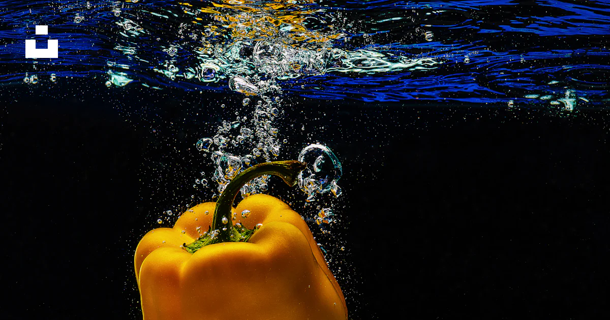 A yellow pepper is floating in the water photo – Free Bell pepper Image ...