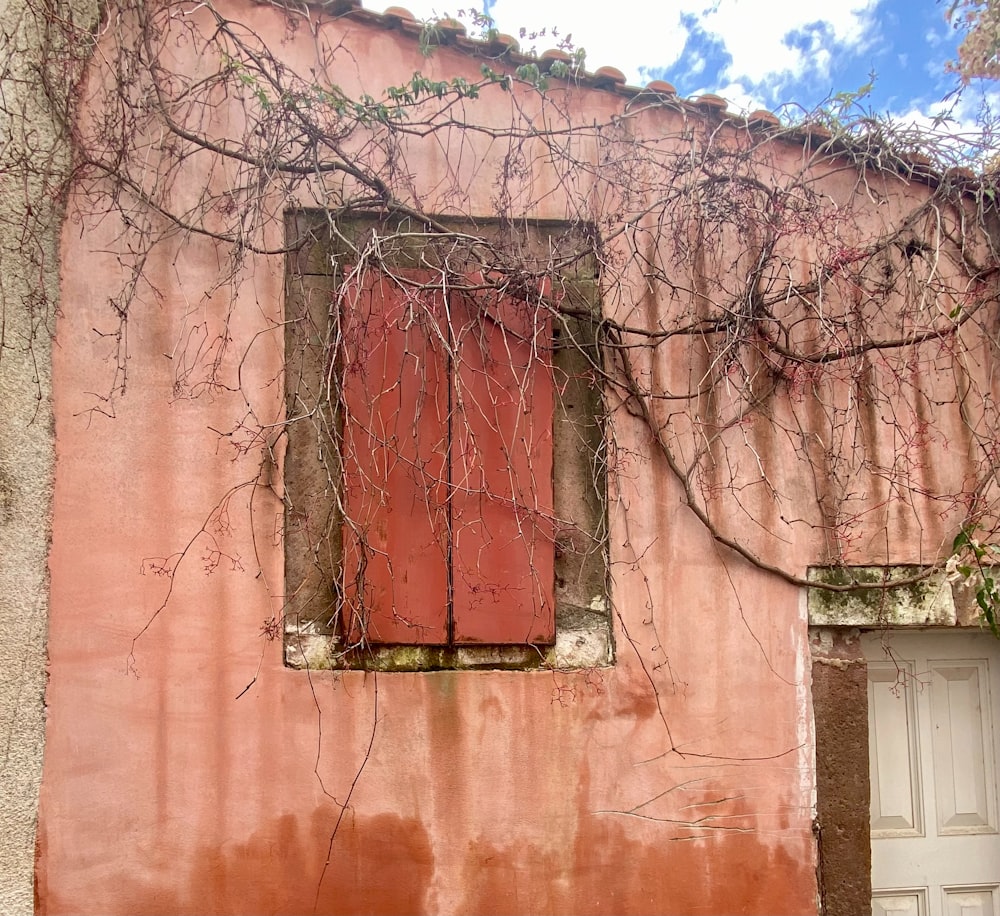 an old building with a red door and window