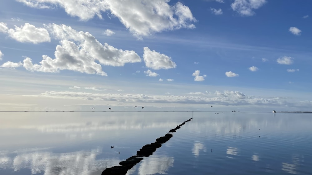 a large body of water surrounded by clouds